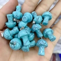 Blue turquoise stone mushroom pendant with silver bail shown in hand for scale - Turquoise (Synthetic)