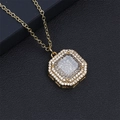 Detailed close-up of octagonal gold pendant with micro-paved cubic zirconia on leather - White