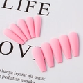Detail shot of matte pink long coffin press on nails in a fan shaped arrangement - Peach Pink