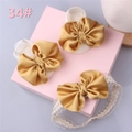 Detail of white baby socks and lace headband set with large golden satin bows - Style 34 (White Gold Bow/White Gold Bow)
