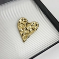 Detailed view of irregular golden heart brooch with textured hammered finish on a tray - 31 Gold Heart (Z-2508)