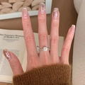 Silver vintage ring with pink accents and crystal stone worn with butterfly press-on nails - Silver Round Clear Main Stone Twist Design Ring (J5352)