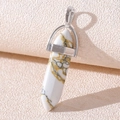 Macro detail of hexagonal white turquoise pendant with silver bail on beige fabric - White Howlite Bracelet