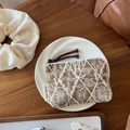Detailed top view of handmade linen embroidered coin purse on a wooden table setup - Khaki