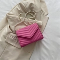 Elegant rose pink chevron quilted crossbody bag featuring a long pearl bead strap - Pink