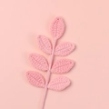 Detailed close-up of pink handmade crochet seven-leaf stem made of soft knitted wool - 7 Leaves / Pink
