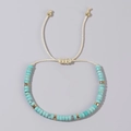 Adjustable hand-woven bracelet with light blue beads and gold spacers on cream cord - Light Blue Turquoise Texture Beads-Cream Cord-Single Bracelet