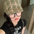 Close-up of yellow and green plaid newsboy cap with vintage embroidery and black shirt - Yellow 19 Thin Stripe Plaid