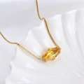 Golden box chain necklace with a yellow marquise-cut gemstone pendant on white silk - Aquarius