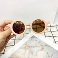 Matte pink round frame sunglasses for kids with translucent brown lenses shown by hand - Kids / Sweet Pink Embroidered