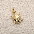 Macro detail of gold-plated turtle pendant with clear zircon inlay and geometric texture - A0778 Zirconia Turtle