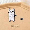 White cartoon cat enamel pin with black outline and funny quote for backpacks - It's fine