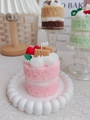 Close-up of pink double-layer strawberry cake candle with cream and berry topping - Pink Cake (Peony & Blush Suede)