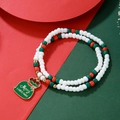 Close-up of a double-layered Christmas beaded bracelet with a festive gift bag charm - Blessing Bag