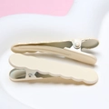 Close-up of cream wave-shaped hairpins on a white tray, durable electroplated metal finish - Off White