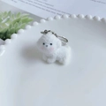 Cute white flocked puppy keychain with silver lobster clasp on a white decorative plate - Blushed Style 3