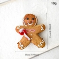 Gingerbread man ornament with dimensions 11cm by 10cm on a white snowy texture - Gingerbread Man