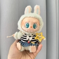 Green Labubu plush doll wearing blue denim dress and striped top with yellow star accessory - Beach Bikini Set / First And Second Generation Keychains Are Compatible With La Cloth Dolls. Dolls Not Included.