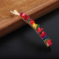 Golden hair clip with natural colorful crystal stones on a dark surface and wood - Colorful Shell Gold