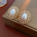 Detailed macro view of vintage gold earrings with imitation pearl and marquise rhinestones - 925 Sterling Silver Earring Post - Gold Vintage Oval Pearl Rhinestone Studs
