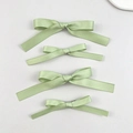 Detailed view of four light green satin ribbon hair bows with silky texture and fine sheen - Green (4pcs Set)