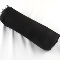Solid black cotton linen pleated scarf featuring frayed edges in a compact rolled style - Black