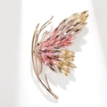 Close-up of butterfly brooch with sparkling crystals and rose gold plated alloy base - Pink