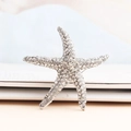 Sparkling starfish brooch with silver alloy base and clear rhinestones for formal wear - White