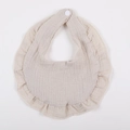 Detailed macro of a beige cotton crepe baby bib featuring ruffled edges and snap button - Khaki