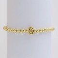 Elegant gold beaded bracelet featuring a polished letter C pendant on a display stand - Gold C