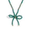 Deep green faceted crystal bead necklace with golden spacers and bow pendant - Peacock Green Transparent