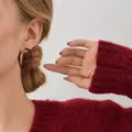Close-up detail of a 4cm red twisted hoop earring worn by a model in a red sweater - 30# Silver Post - Red 4.8cm