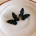 Vintage black butterfly stud earrings set with rhinestones on a textured ceramic plate - Black Hollow Butterfly Zircon Stud Earrings