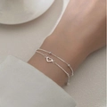 Delicate double-layer silver bracelet featuring small round beads and a hollow heart pendant - Silver