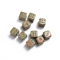 Close-up of 15mm natural stone dices with red and green marbled texture on white background - Unakite