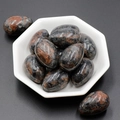 Set of 11 polished egg-shaped natural agate stones with red patterns in a white bowl - Sesame Stone (1pc)