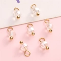 Golden faceted crystal pendants for DIY jewelry making on soft background - Iridescent Round Bead