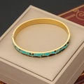 Detail of a gold stainless steel bangle featuring blue and black enamel geometric patterns - Blue & Black Geometric (6#)