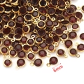 Close-up of 6mm gold stainless steel pendants with dark red crystal birthstone charms - Dark Wine Red