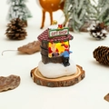 Detailed view of glowing miniature Christmas Gift Shop resin house on wooden base - Gift Shop