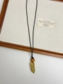 Detail view of golden wheat stalk pendant with amber bead on black cord necklace - Golden Wheat Ear