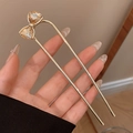 U-shaped hair pin with a gold finish and champagne crystal bow shown in hand - Rhinestone Bowknot Hair Stick - Gold