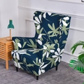Elastic wingback chair slipcover with dark blue background and white green leaf pattern - Leaf Dance