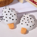 Close-up of resin ice pop charms in white with black dots for DIY phone case craft projects - Dotted Popsicle / White