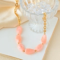 Golden link chain necklace with irregular pink natural stone beads on silk background - Stainless Steel Marble Pattern Necklace / Orange