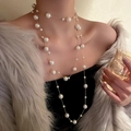 Close-up of elegant layered baroque pearl necklace with refined gold chain link details - Gold White
