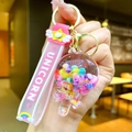 Detail of pink unicorn wristband with rainbow pattern and glowing candy beads keychain - Glow-in-the-dark Rainbow Candy Beans [cheese Sticks]