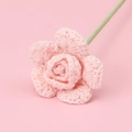 Close-up of a hand-knitted pink rose flower made from soft yarn for home decoration - Pink