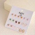 Macro shot of a 9-pair earring set featuring crystal, pearl and gold geometric designs - Colorful Crystal Pearl Flower Earrings (E0193-1)