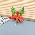 Detailed view of Christmas cake topper with green holly leaves, red berries, and gold bells - Leaves-2001